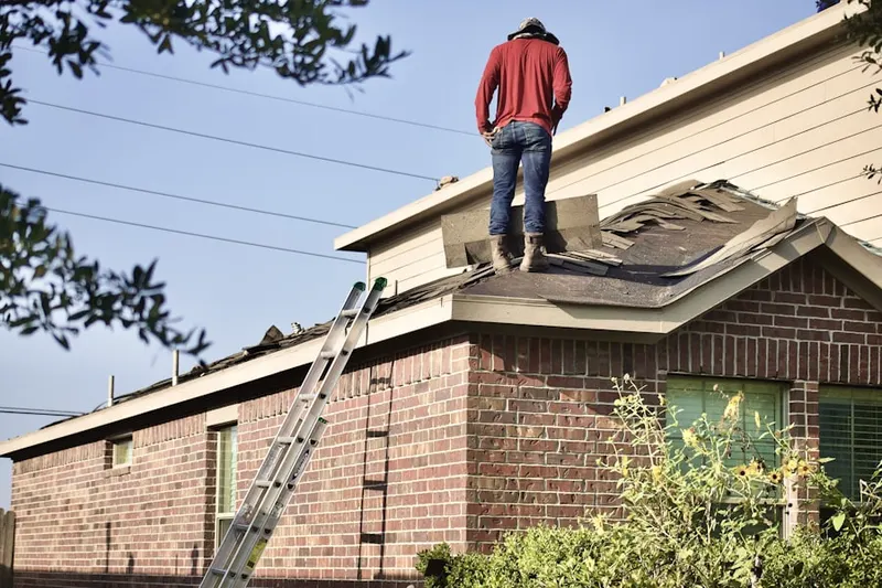 Professional roofer working on a residential roof in Manitou Springs